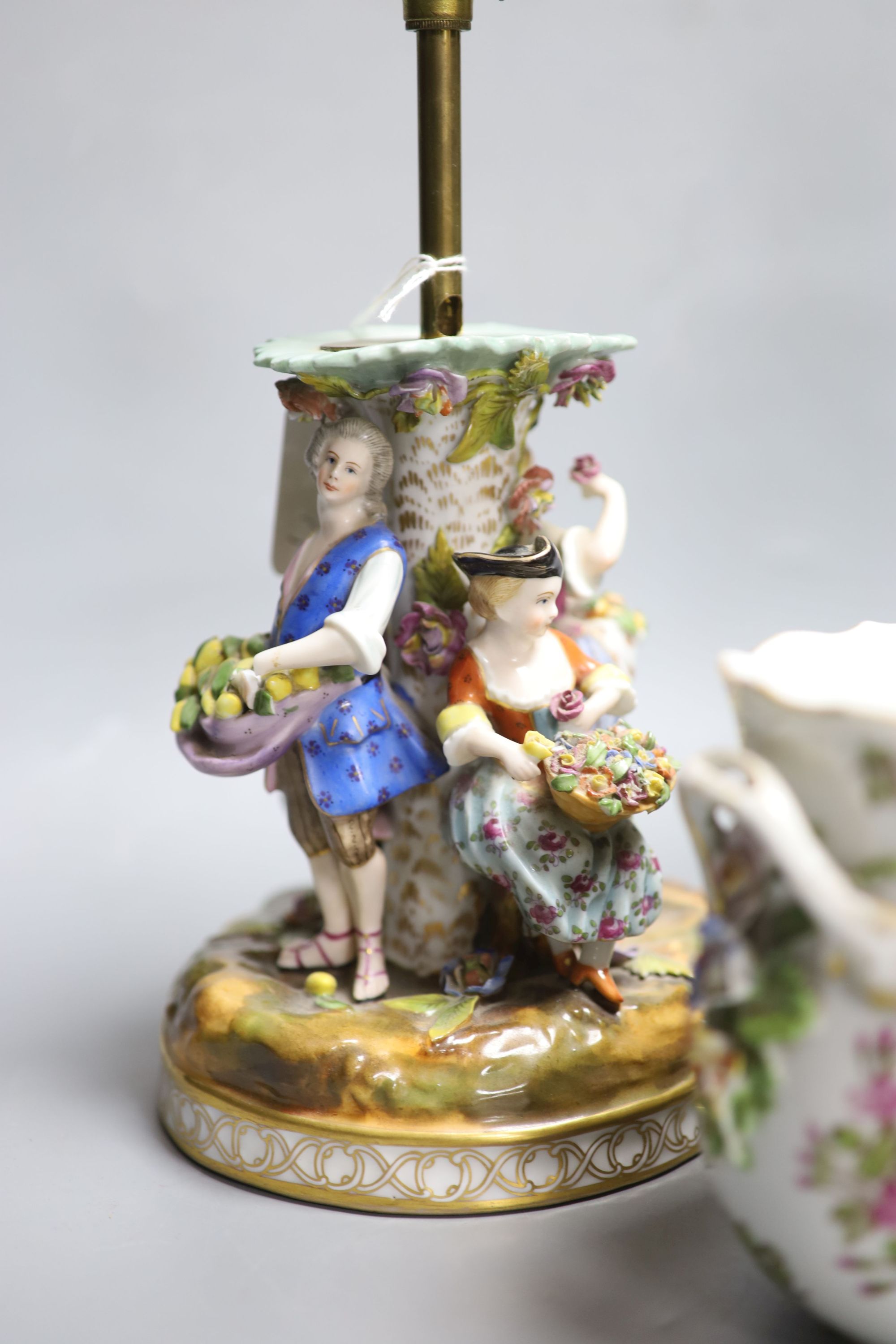 A Dresden figurative lamp, another similar lamp and a bowl with swags of flowers, tallest 28cm